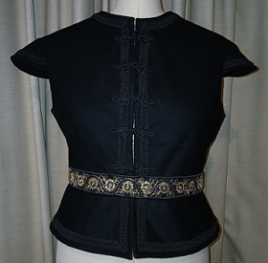 Isabel Maria's sleeveless, black wool doublet, displayed on a dress form.