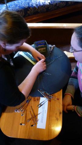 Ginevra-shows-Caterine-how-to-finish-her-lace